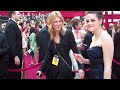 kristen stewart walks by fans at the 2010 academy awards.