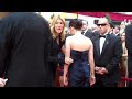 kristen stewart walks by fans at the 2010 academy awards.