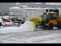 Plowing a parking lot with a Machinability 8'V35 snow plow on a trackless machine.www.machinability.com