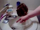Razoo atempting to drink water from the faucet