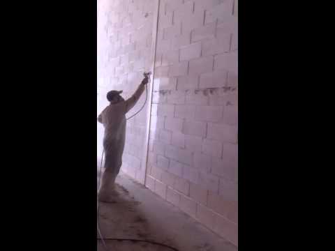 operating a graco 695 - Spraying some more factory walls, pump runs out of paint.