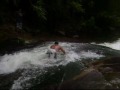 Tentando deslizar em pé na Cachoeira do Sana