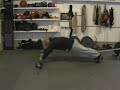 February 2010 - This video shows Ross Enamait demonstrating standing rollouts with a barbell. A progression using resistance bands is also included. A related blog entry can be found here: rosstraining.com