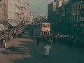 A tram ride down Queen Street and Cardiff University students dressed up for charity during Rag Week.This extract comes from Claude Friese-Greene's 'The Open Road' - originally filmed in 1925/6 and now re-edited and digitally restored by the BFI National Archive. Britain seen in colour for the first time was heralded as a great technical advance for the cinema audience - now we can view a much improved image, but one which still stays true to the principles of the colour process.The rather haphazard journey from Land's End to John O'Groats creates a series of moving picture postcards. Look out for shots containing the component colours - red and blue-green - such as when a little girl in a red coat and hat walks among peacocks in the grounds of a castle, and three girls with red curly hair pose by the sea at Torquay.The car is a Vauxhall D-type - considered a sporty model at the time. A long-distance journey by car was a relatively new concept, with none of the amenities en route now taken for granted. The visit to a petrol station shows smoking on the forecourt: no health and safety issues back then! The travelogue ends with a series of recognisable London landmarks. Much remains the same - one major exception being the volume of traffic on the roads. (Jan Faull)For more information about 'The Open Road' see http://www.bfi.org.uk/features/openroad/  To buy the DVD click here - http://filmstore.bfi.org.uk/acatalog/info_6406.htmlYou can watch the whole of 'The Open Road' and 1000 other complete films and TV programmes from the BFI National Archive free of charge at the new BFI Mediatheque - http://www.bfi.org.uk/mediatheque
