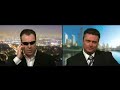 ben price as arnold schwarzenegger being interviewed by james o'neill in a mock satellite interview