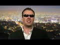 ben price as arnold schwarzenegger being interviewed by james o'neill in a mock satellite interview