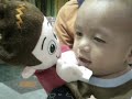 baby echo playing with a puppet