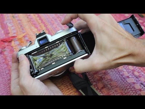 how to open a minolta xg 1 camera