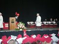tuchi walking across the stage recieveing his diploma