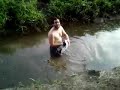 Joseph searching for disc golf discs in a polluted stream!
