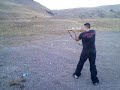Bryan firing shotgun.