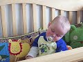 Dozing in his crib Dozing in his crib
