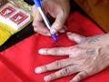 Ajaan Ord writing yant/s (magic symbols) on my shirts of protection. He would later re-bless them.