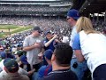 Yankee fan argues with a Cubs fan during a Cubs/Mets game