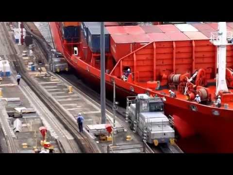 ship - Panama Canal tow train or mule being crushed as it was pulling a container ship on April 03, 2014.
