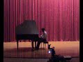 Emrah performing in auditorium with piano Emrah performing in auditorium with piano