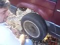 Courtland changing tire on Ford Aerostar van