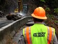 Workers with heavy equipment had cleared all but a few boulders from a rockslide that blocked US Highway 64 this morning when, with a tremble and a roar, another huge slide spilled across the road and into the Ocoee River gorge.