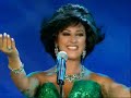 The famous Lebanese singer Najwa Karam was born on the 26th of February 1966 in Zahle, Lebanon. She is the youngest amongst her siblings, she has three brothers, Tony, Jean and Nicola and one sister, Salwa. Najwa studied in Zahle and graduated with a degree in Philosophy, and later became a teacher for two years. Her musical talents were apparent from a young age where she used to sing at some school parties with her friends. Najwa's father initially disapproved of her interest in musical profession.