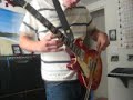 guy plays violin bow on guitar