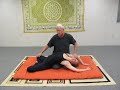 Ardis Matsyendra, or the asymmetrical facilitated whale/ fish pose or back bend. The client starts in Padmasana and the therapists is in Virasana at right angles behind the client. This Yoga bridge emphasis one side of the spine more than the other . This allows the asymmetrical emphasis to address a one sided imbalance more specifically. can be done with the hands in the low position when the client is restricted or with the hands extended for full emphasis. Back bends are considered one of the most important of Yoga asana and generally have the following benefits: Release and extension of the anterior spinal muscles. The posterior range of motion counterbalances head forward postures both in practice and pathological such as inclinations to 