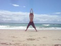 Kathy enjoying yoga on the beach during her Vibrance Laughter Tour
