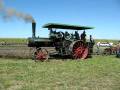 Steam tractor backing up to hitch to a plow