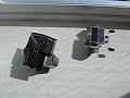 The robot on the left uses the 1381 solar engiene and 3 solar cells. It has a shell on the bottum and uses walkman motors. The one on the right uses a FLED SE and the same motors.