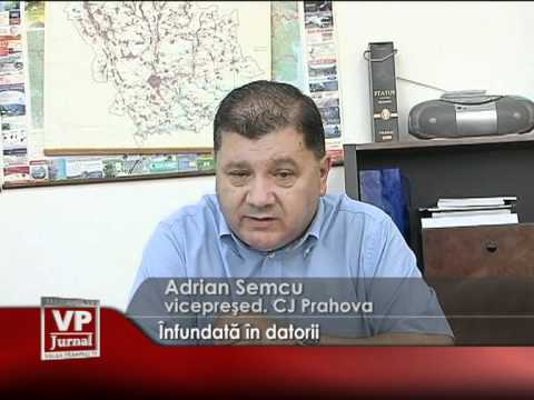 Înfundată în datorii