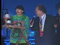 noel lee presenting santana with a monsterous award