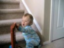 Liam walking behind his Tonka