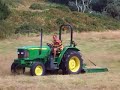 this is a john deere 5415 cutting grass with a topping mower on the island of herm in the channel islands.