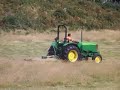 this is a john deere 5415 cutting grass with a topping mower on the island of herm in the channel islands.