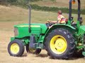 this is a john deere 5415 cutting grass with a topping mower on the island of herm in the channel islands.