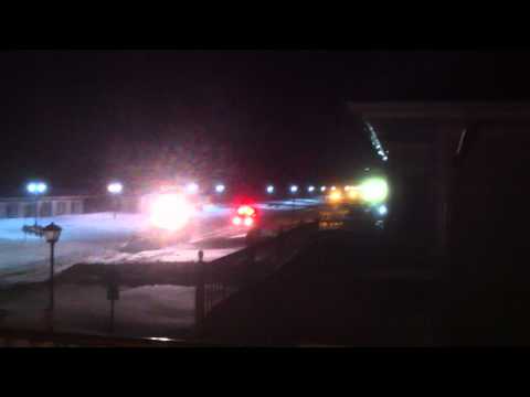 0 Blizzard Ambulance going down the street with front end loader