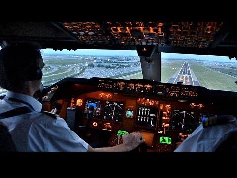 View - Cockpit view of a Boeing 747-400ERF landing at Amsterdam Schiphol airport during sunset after a 7 hour flight from Abu Dhabi.