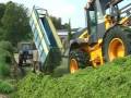 Watch one of the best on a JCB shovel push a load of grass every minute from two harvesters (with a little help from his mate :)