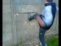 Vandal kicking a concerete wall