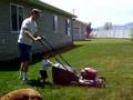 Logan mowes the lawn with dad