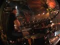 from behind the drums
