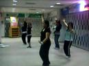 Mel counts and instructs while girls work out the moves with the music