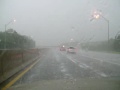 crazy lightning during wild rain/hail storm on highway