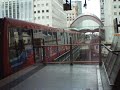 New DLR train arriving & departing Heron Quays for Lewisham