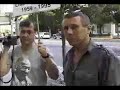 Scientology handler pressing face into camera