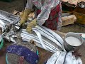 A woman chops off fish heads at Jagalchi Fish Market, Busan