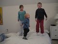 Nate, Emma and Matt bounce on the mattress