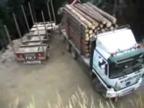 extreme driving - Jak to taky lze otočit :-)Hazardous cargo rigs turning on a steep slope. Car wood, forest road, danger, courage, experience Narrow Road, high hills.
