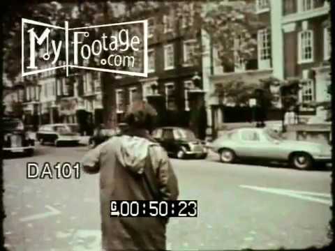 1970s - Various shots of New York City, 1970s. Crowds of rush hour passengers getting onto subway; shots of city bus covered with grafitti; Yellow Cabs driving up a ...