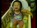 Baby  Thalia in her crib calling in telephone