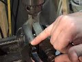 Removing the old rivets from the trunnions